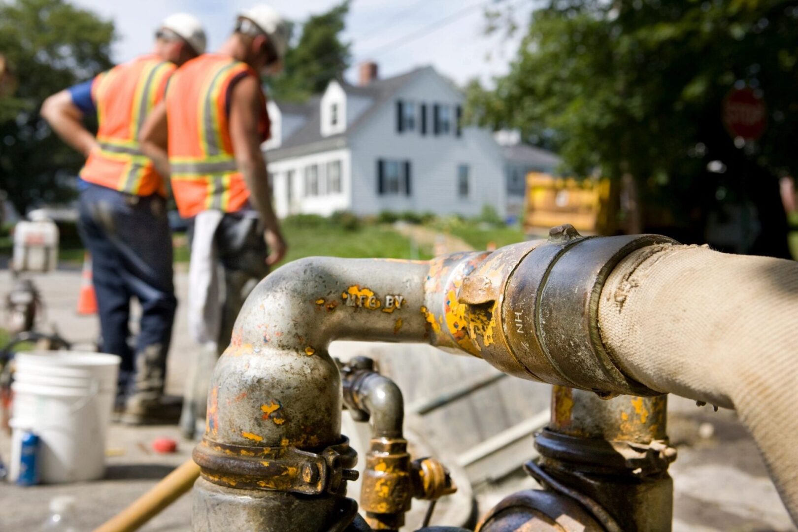 Plumbers working on a street pipeline