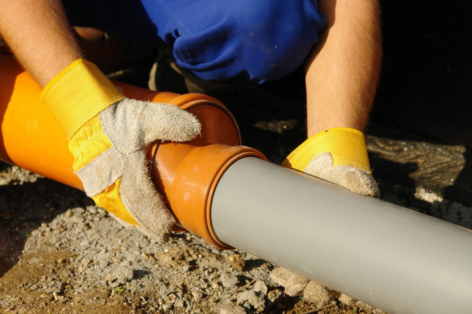 A plumber fixing an underground pipe